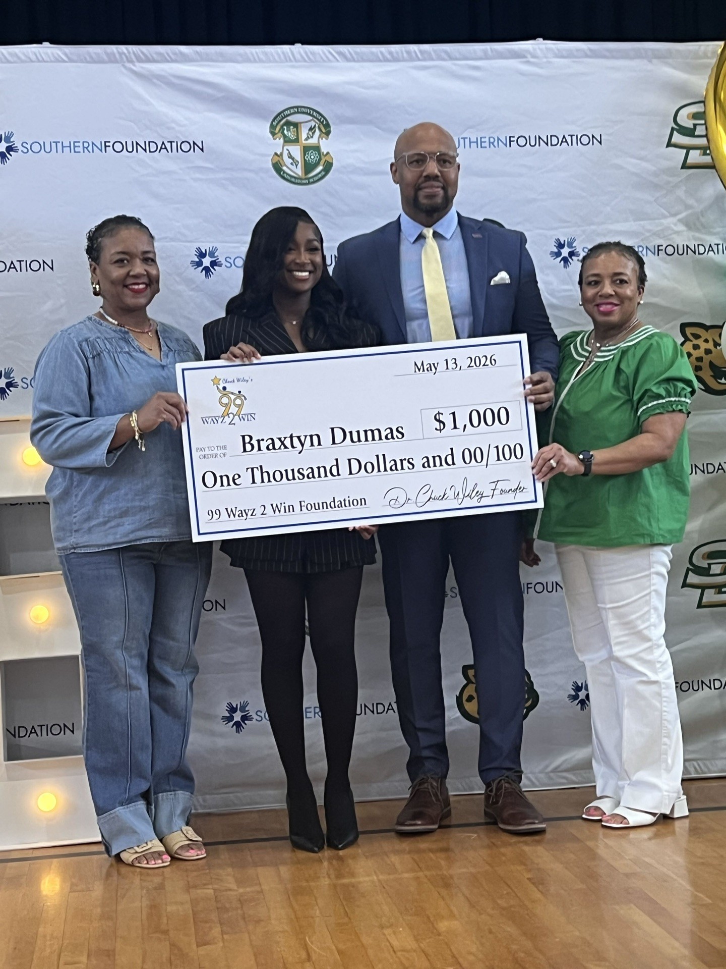 Chuck Wiley presenting a scholarship check to a student