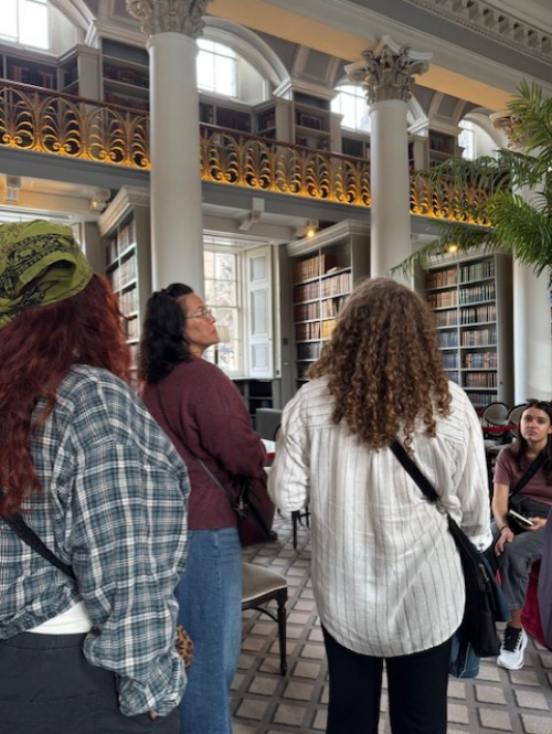 Two SIS Students gaze at books in Wren Library