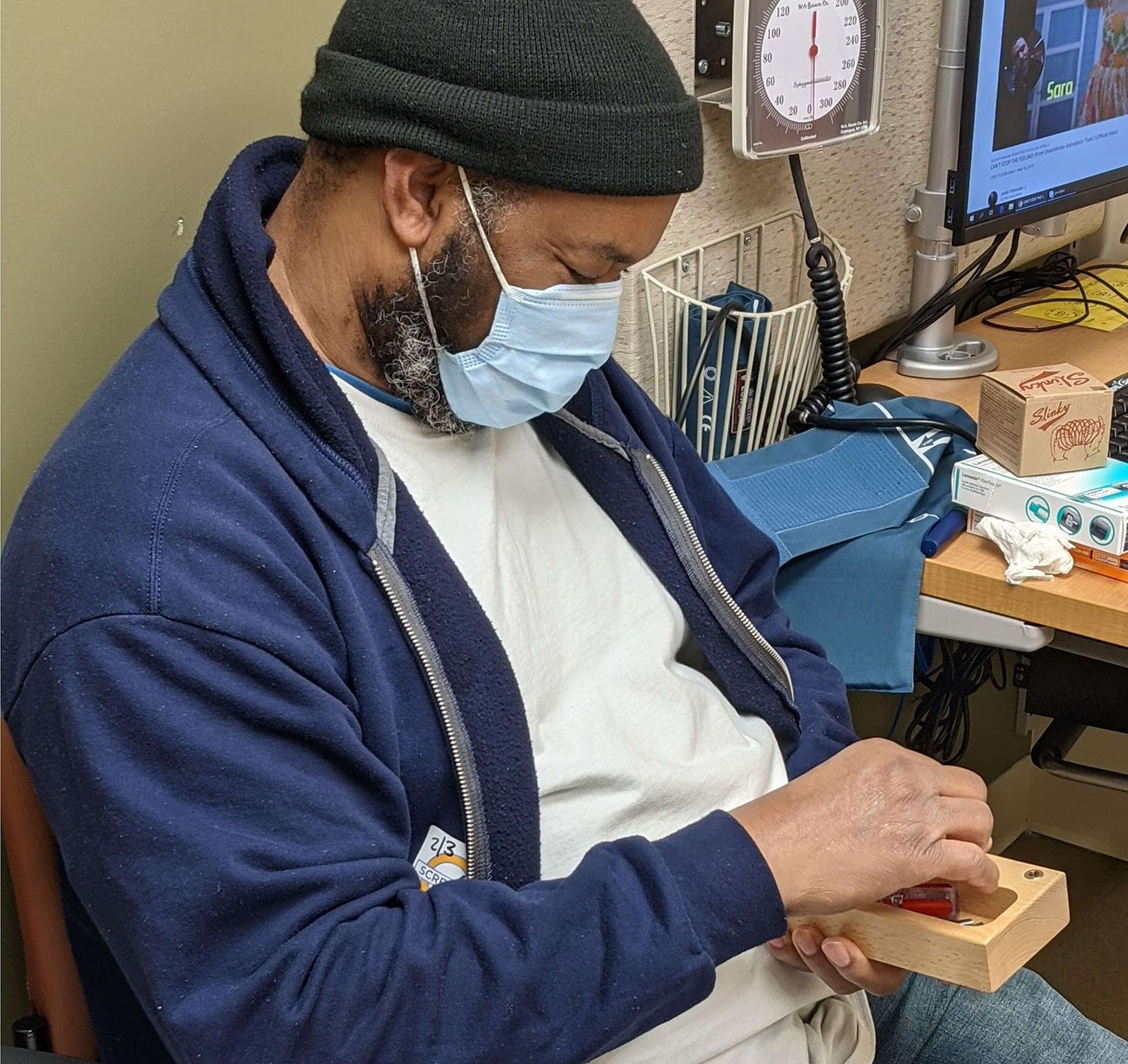 African American male in a doctor's office with a dementia engagement kit