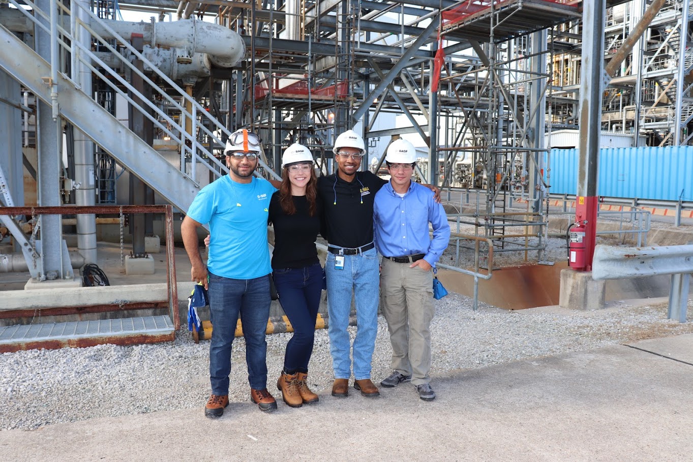 Photo of three male and one female LSU Engineering Student outdoors at BASF