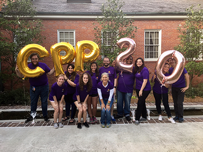 11 members of the CPP Design Team holding mylar balloons that spell out "CPP 20"