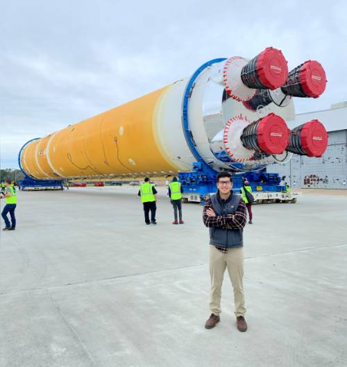 Alex Cagnola standing in front of rocket