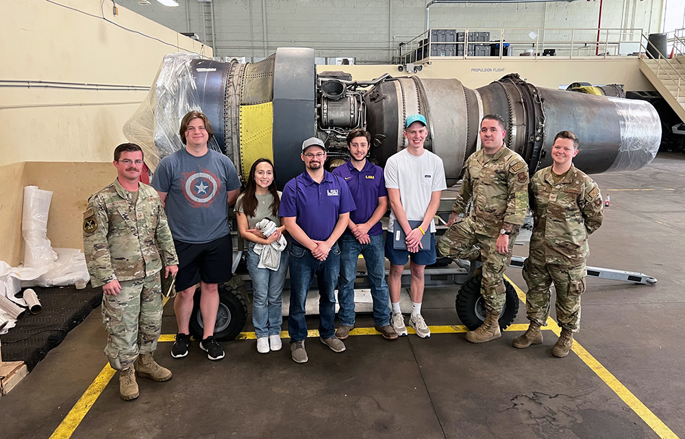 Group photo in front of a B52 engine