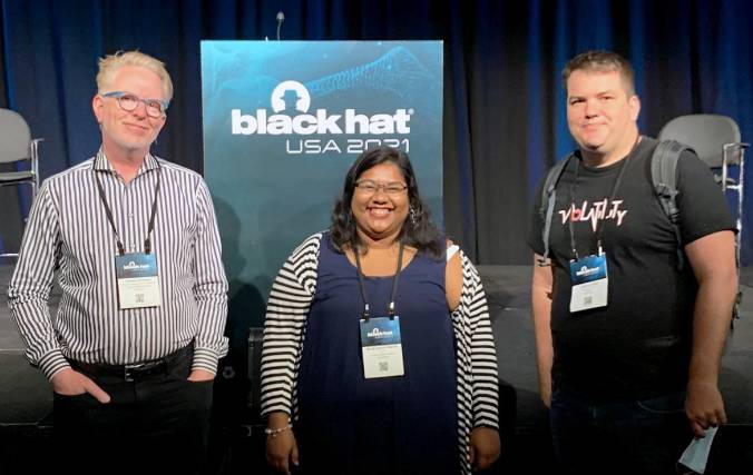 Gold Richarden, Modhuparna Manna, and Andrew Case posing together at the Black Hat Conference