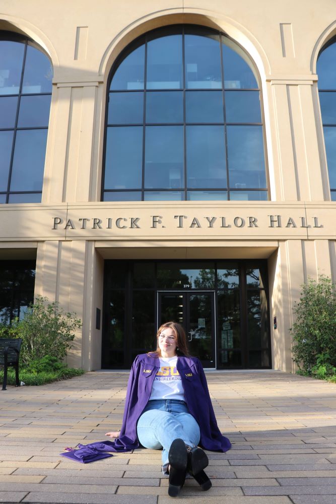 LSU Mechanical Engineering Senior Bailey Smoorenburg sits in front of Patrick F. Taylor Hall