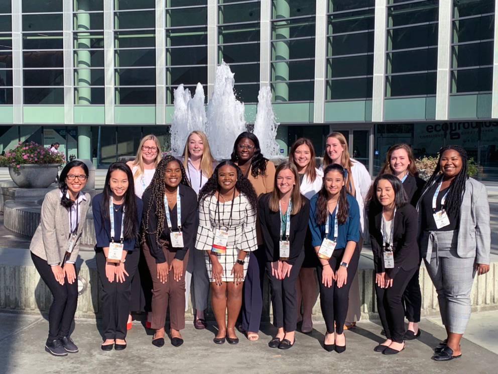 Group photo of women posing in front of fountain at SWE conference