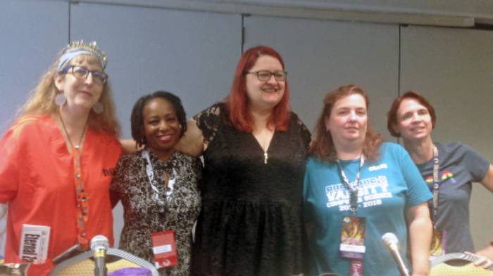 Theda Daniels-Race posing with women's panel at Dragon Con
