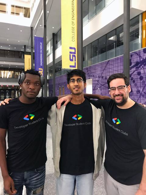 Three members of Google Developer Student Club posing in atrium