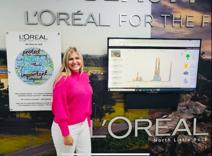 Miller Dickerson in front of L'Oreal presentation board