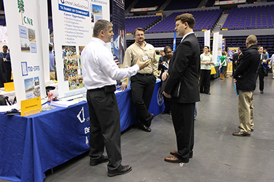 Student talking with recruiters at a networking event
