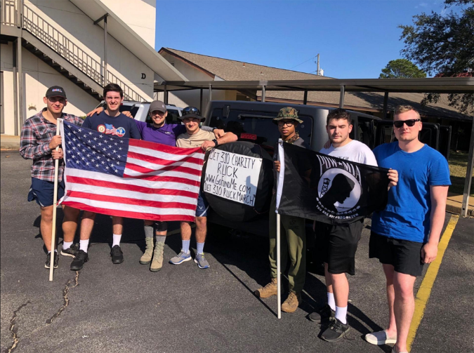Group of ROTC members holding flag