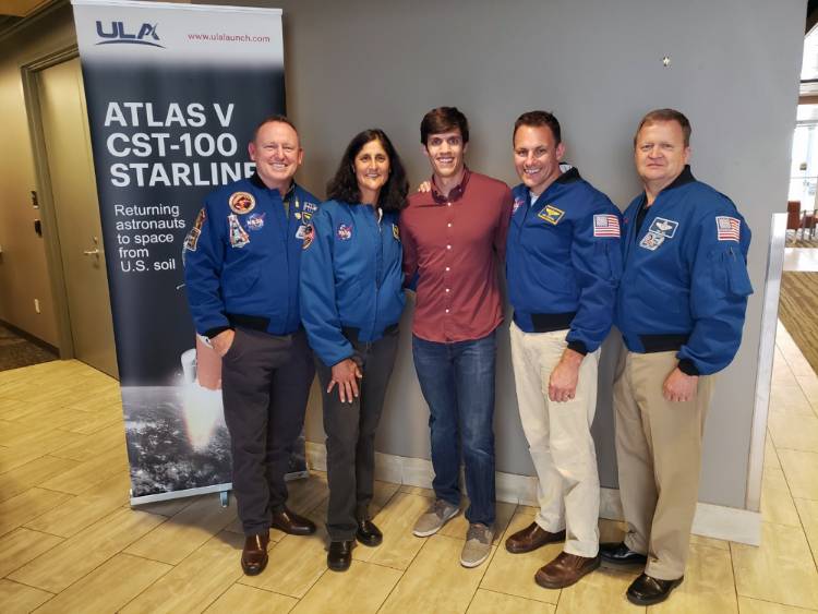 Garrett Sibley posing with four astronauts