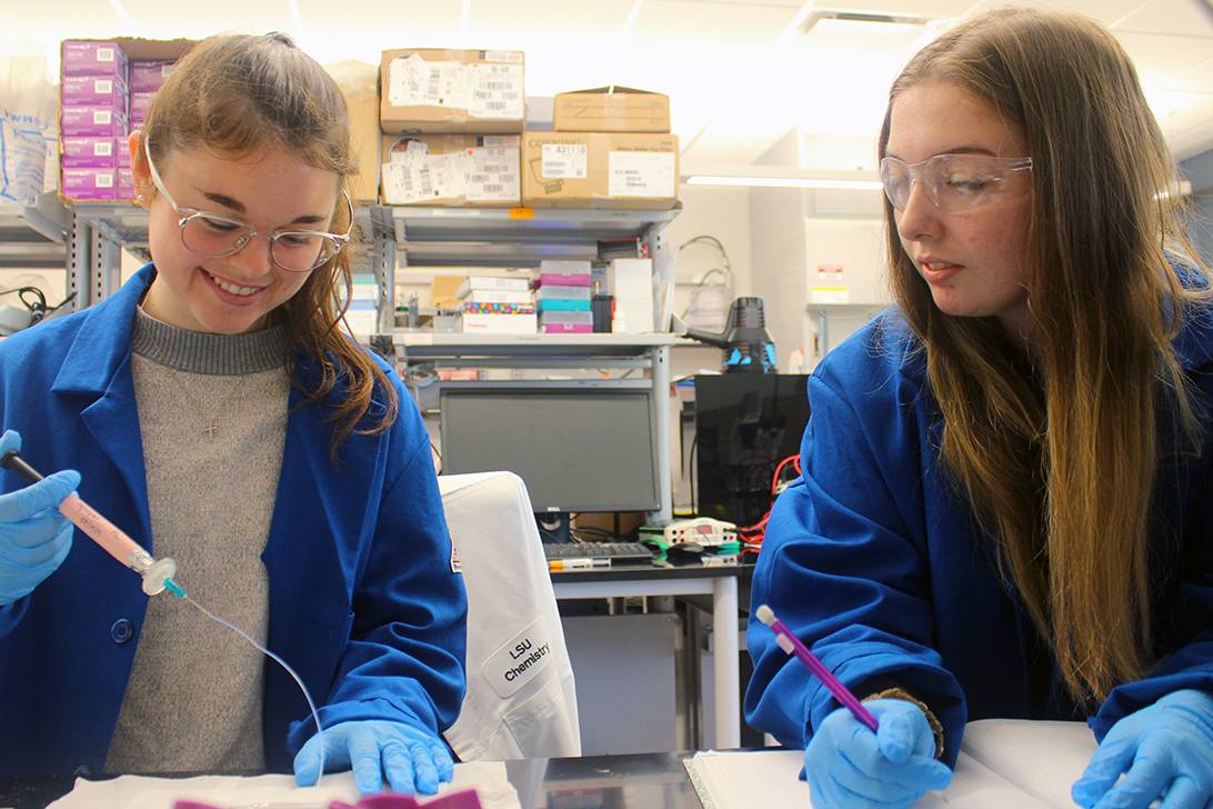 Two female students working in lab