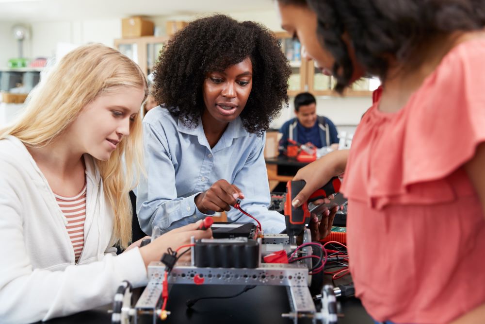 Stock photo of three students working on a STEM project