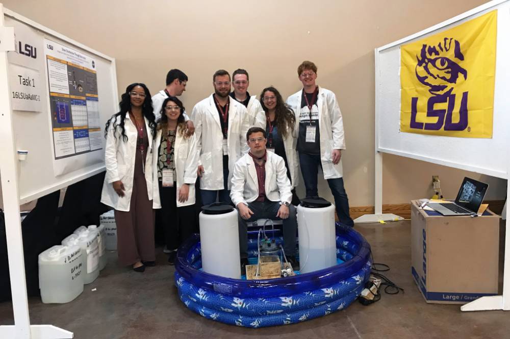 Group photo of students in lab coats at WERC competition
