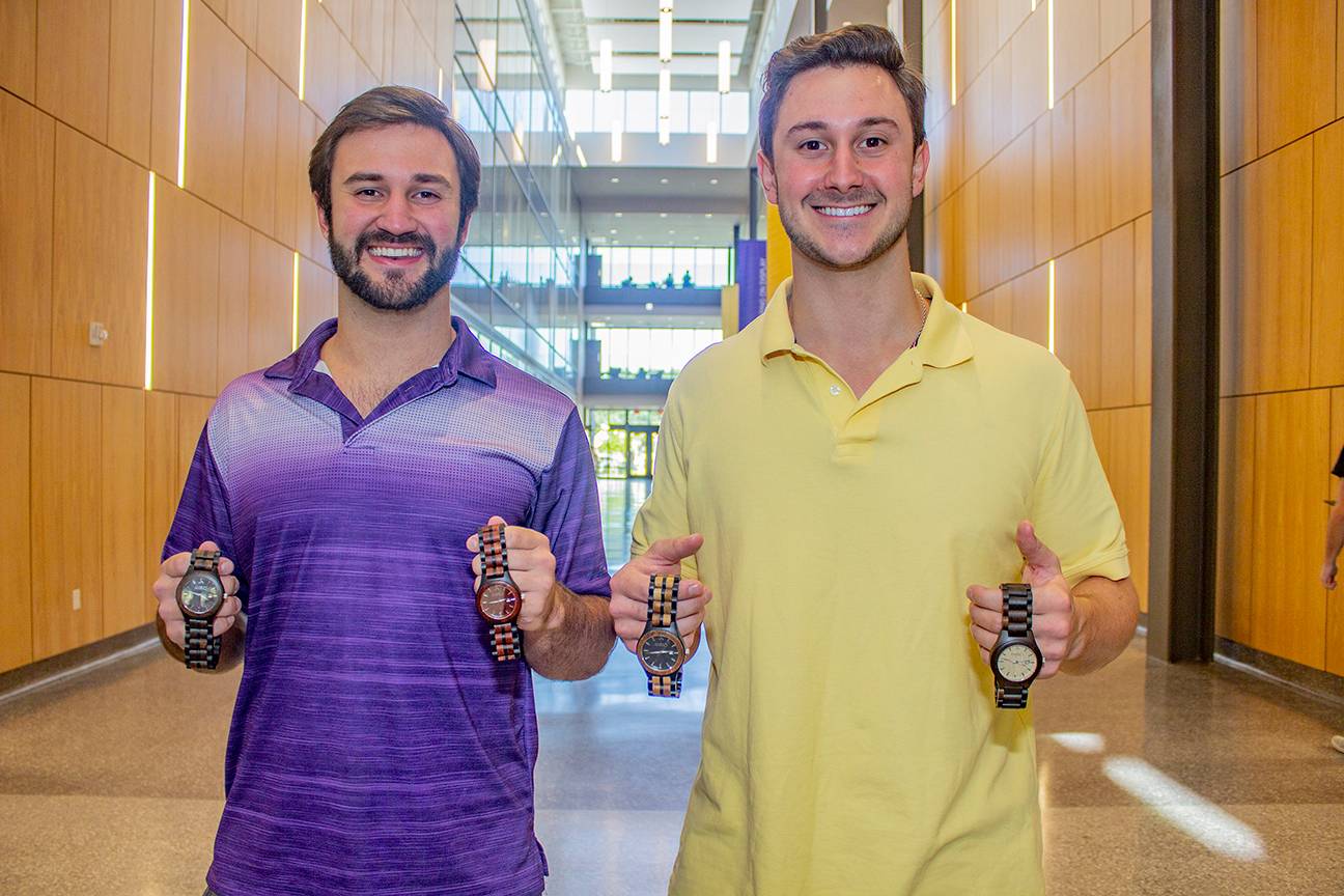 Riley and Reed Stephens holding Ambici watches