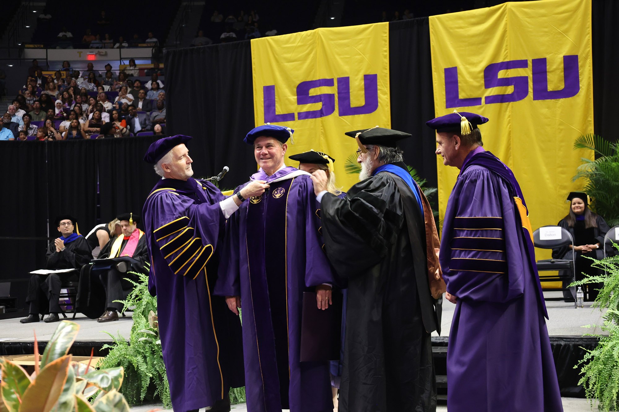 Roy O. Martin is hooded with an honorary doctorate by Chancellor Dalton
