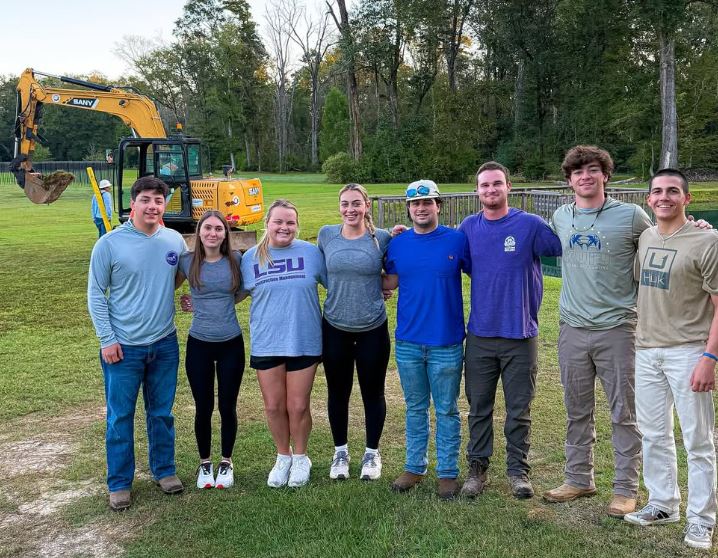 CSA students in front of an excavator