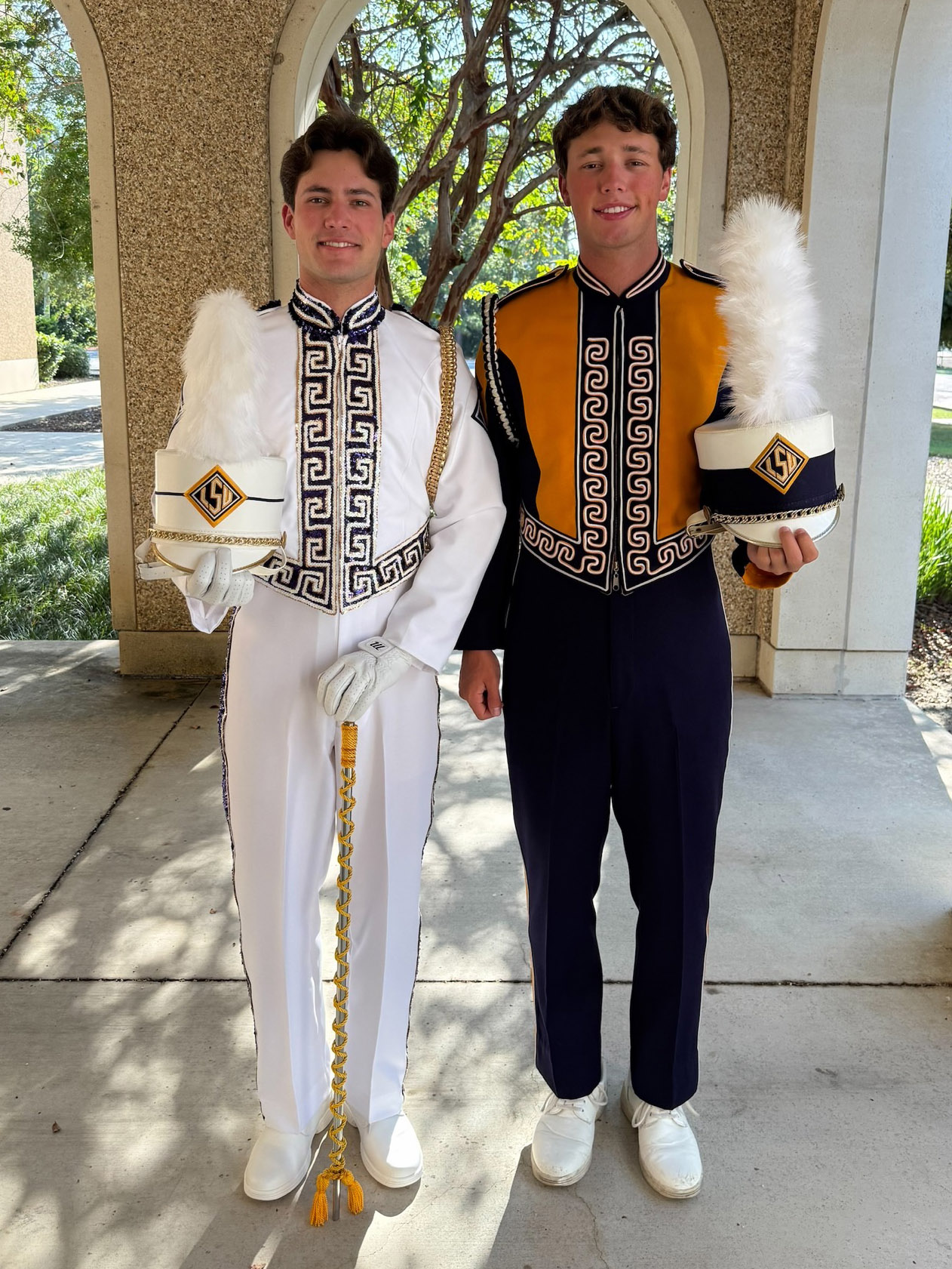 Dylan and Dalton Rousselle in drum major and band uniforms