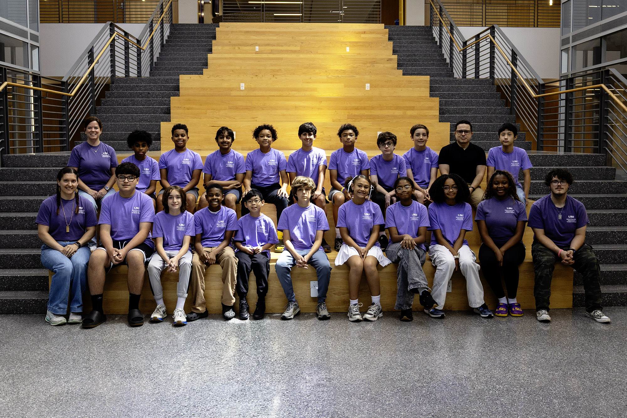 Group photo of campers and leaders on capstone stairs