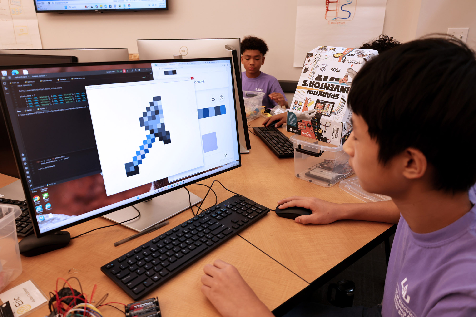 student works on pixelated graphics