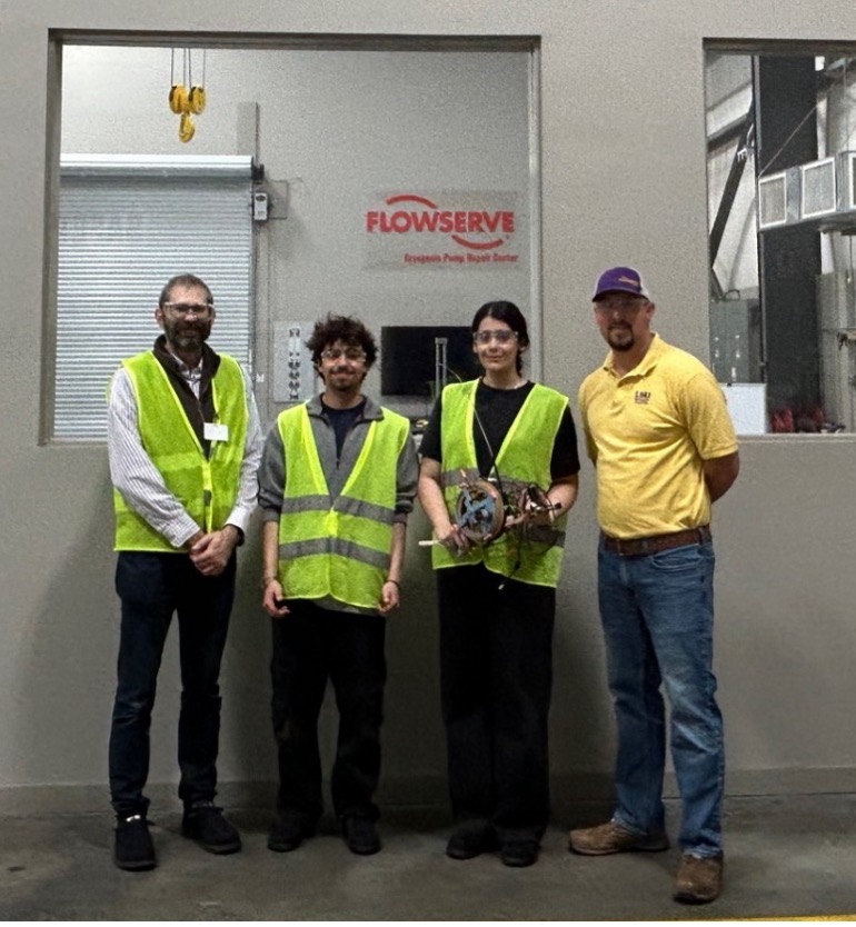 Gilbert and students at Flowserve in a posed group picture