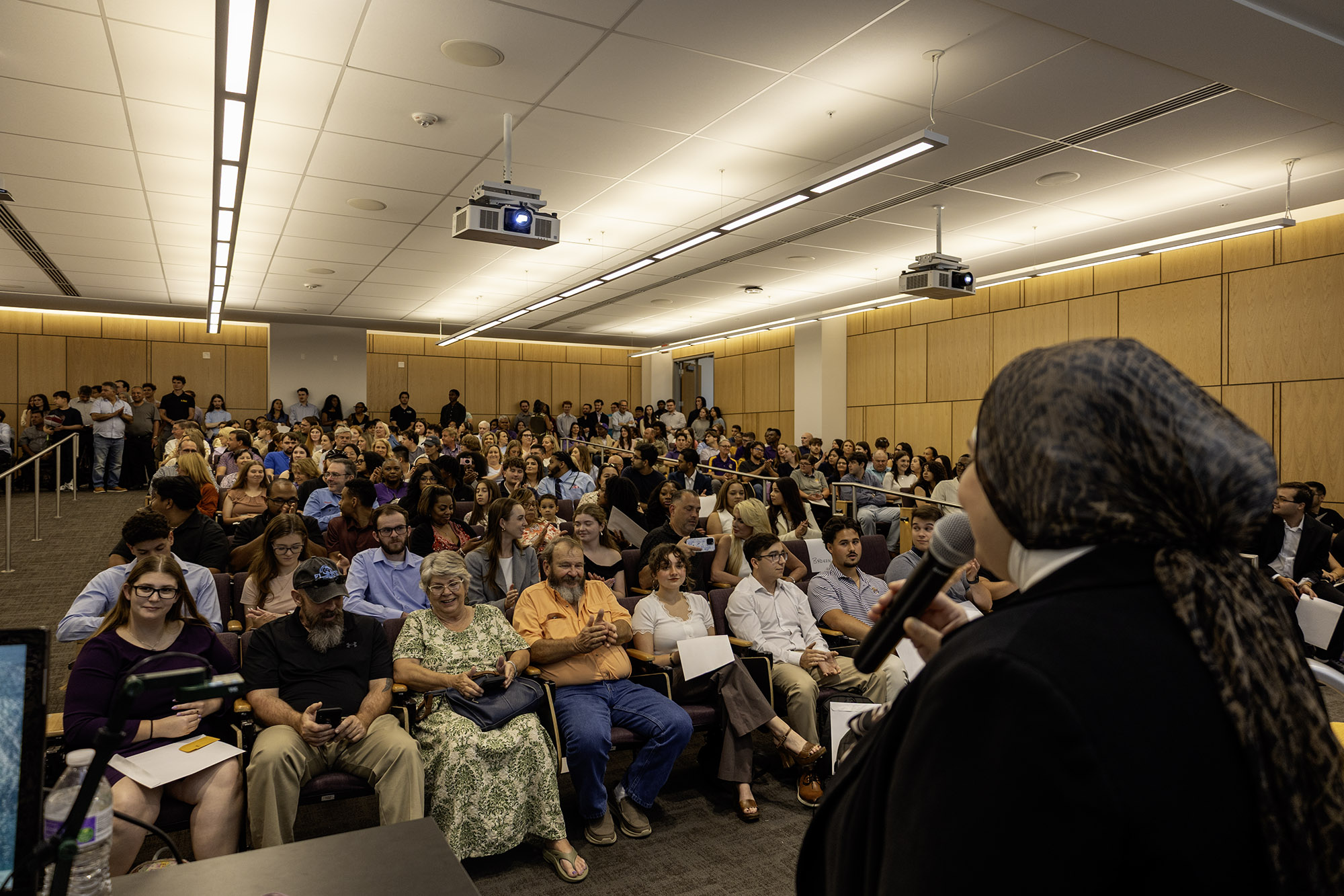 Marwa Hassan speaks to a large room of students and parents