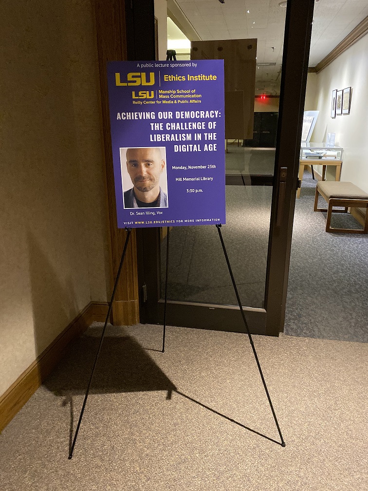 Poster advertising Sean Illing's talk set up in front of the lecture hall 