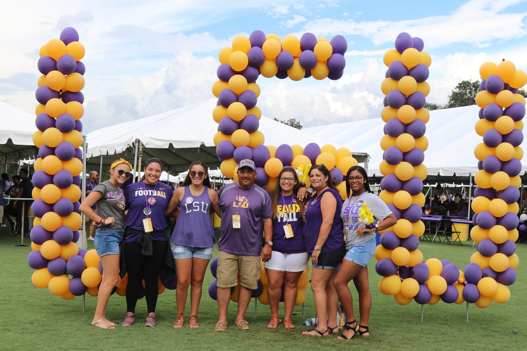 family under LSU baloon arch