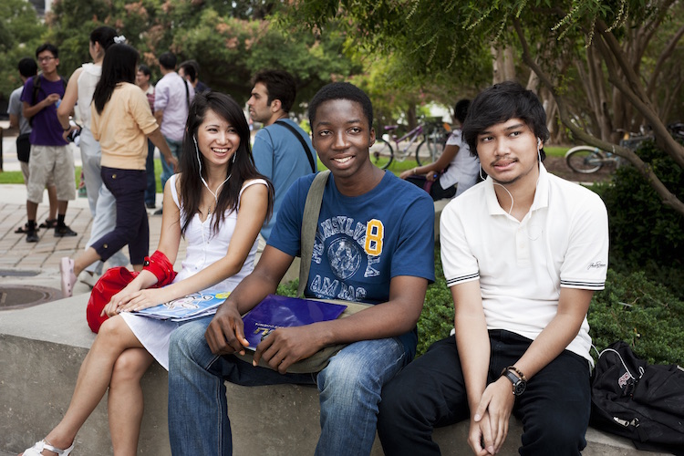 international students on bench in quad