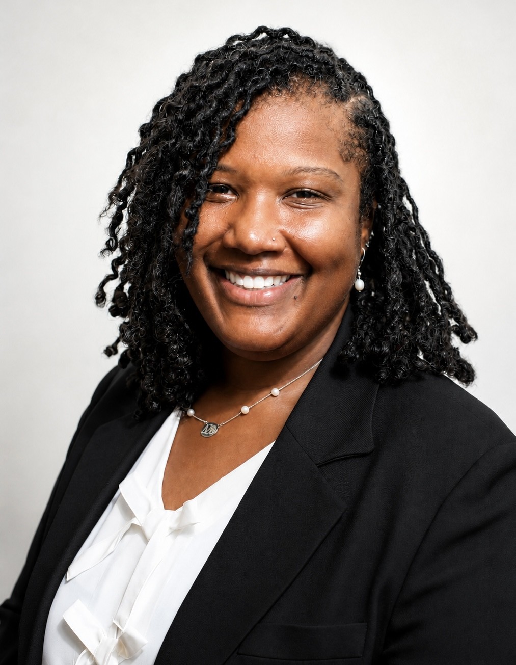 woman wearing black blazer posing for a headshot