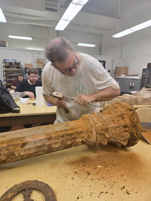 MA student Conan Mills cleaning an iron column recovered during the excavations at the Old LSU Site.