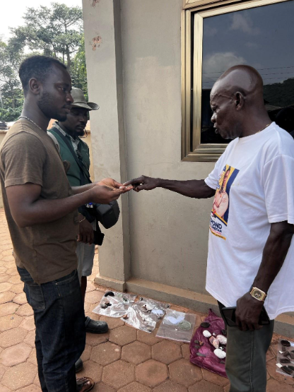 Kelvin Asare (second from left) discussing archaeological finds with local collaborator (right) and archaeologist Albert Appiah (left).
