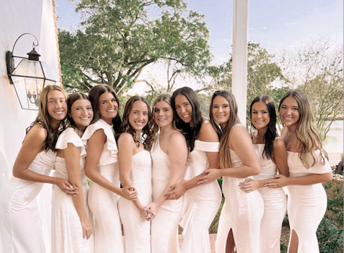 delta zeta members pose in white dresses