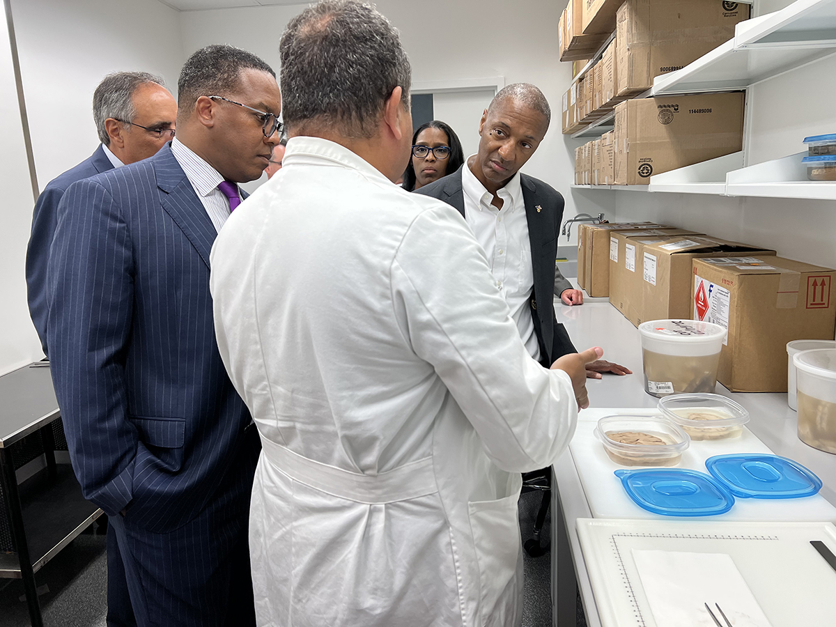 President Tate visits cancer research lab.