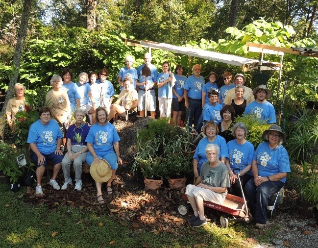 volunteers gathered around the garden soil bin