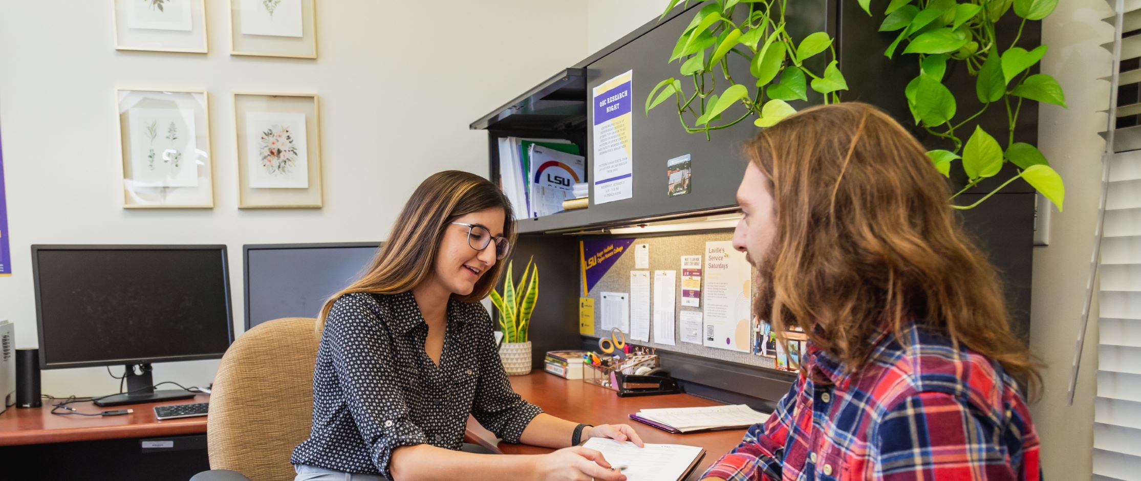 An LSU Ogden Honors College advisor walking through courses with a student.