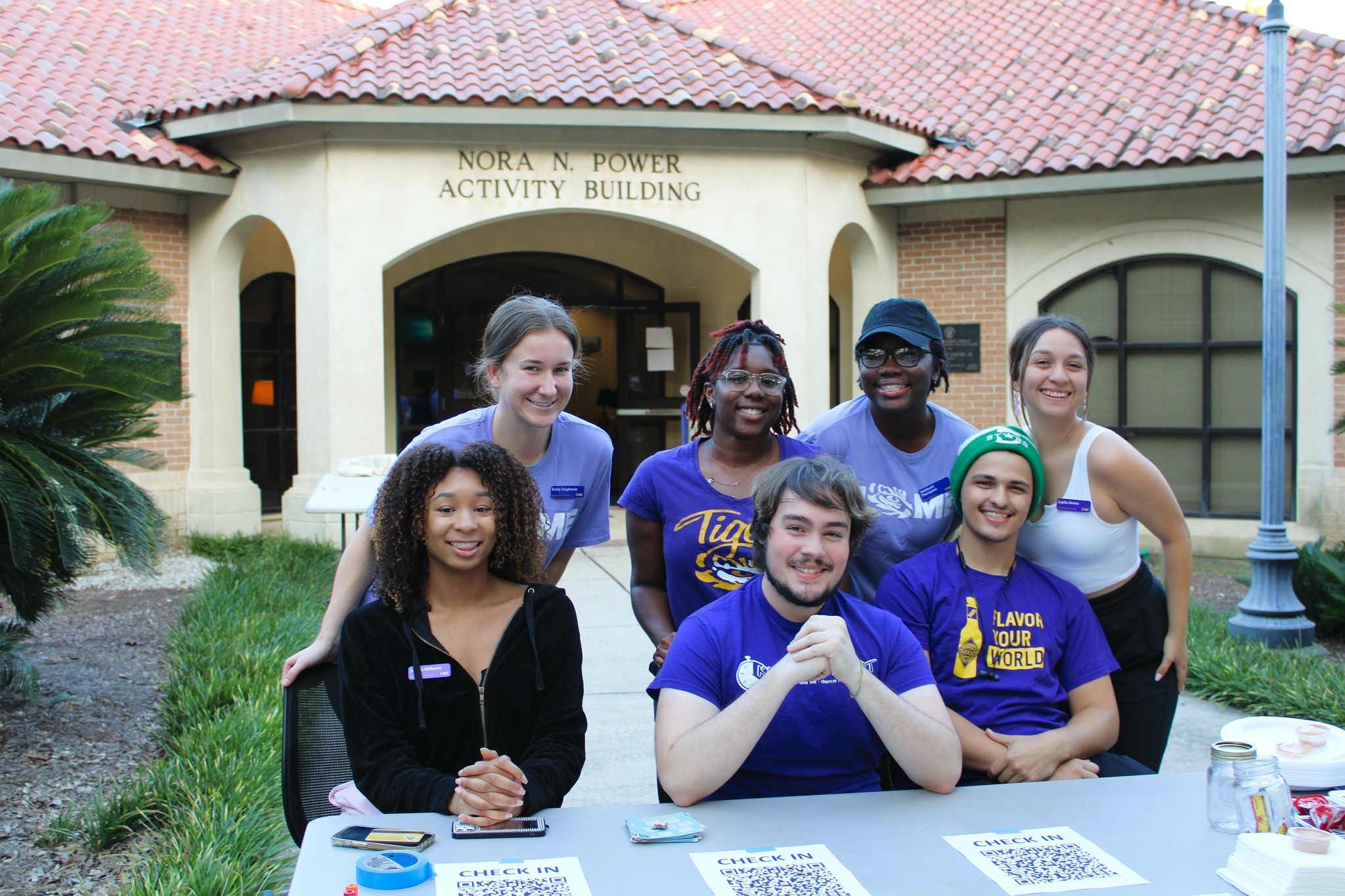 Resident assistants posing for a photo outside of the East Campus Apartments Activity Center.