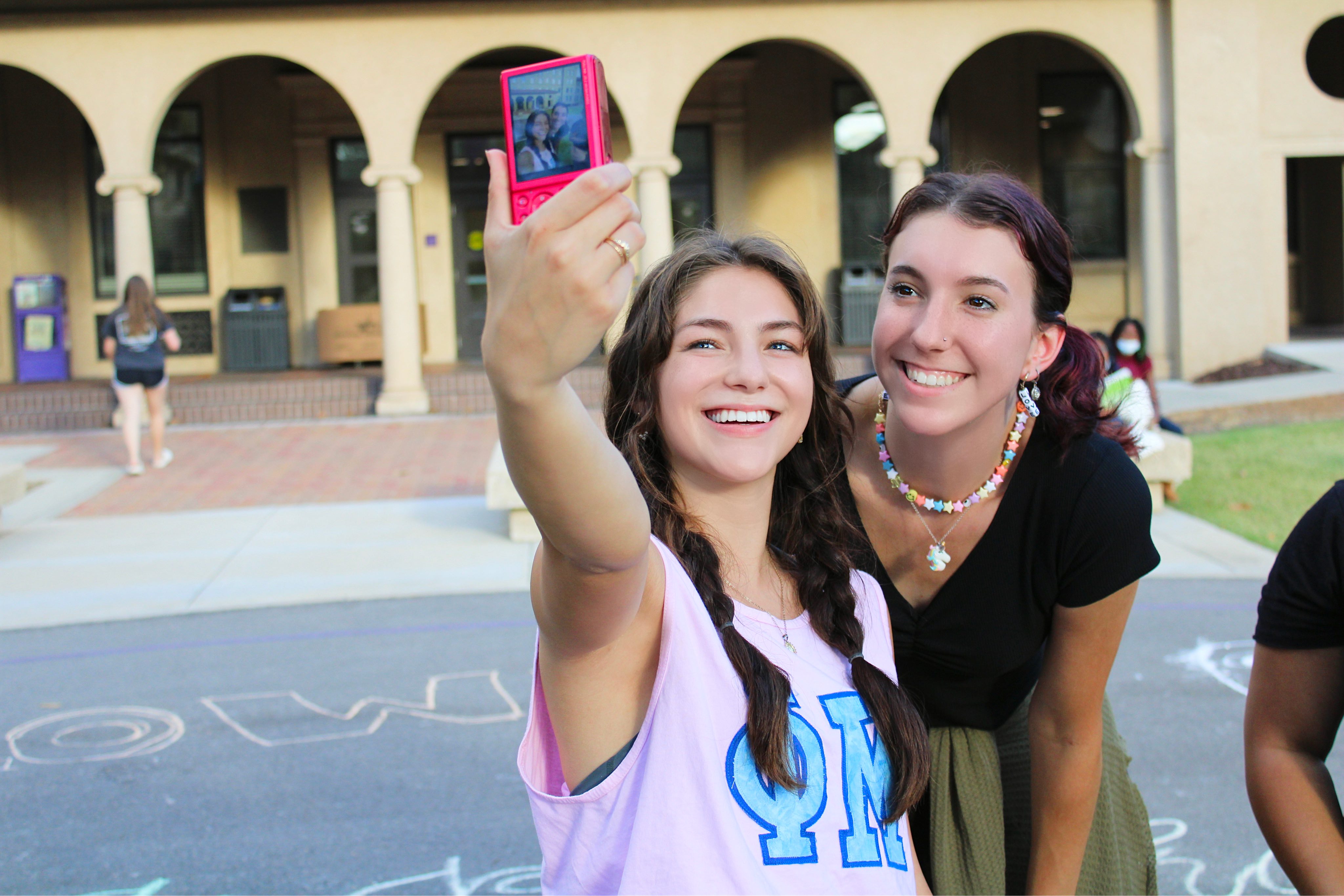 Students taking a selfie with a camera.