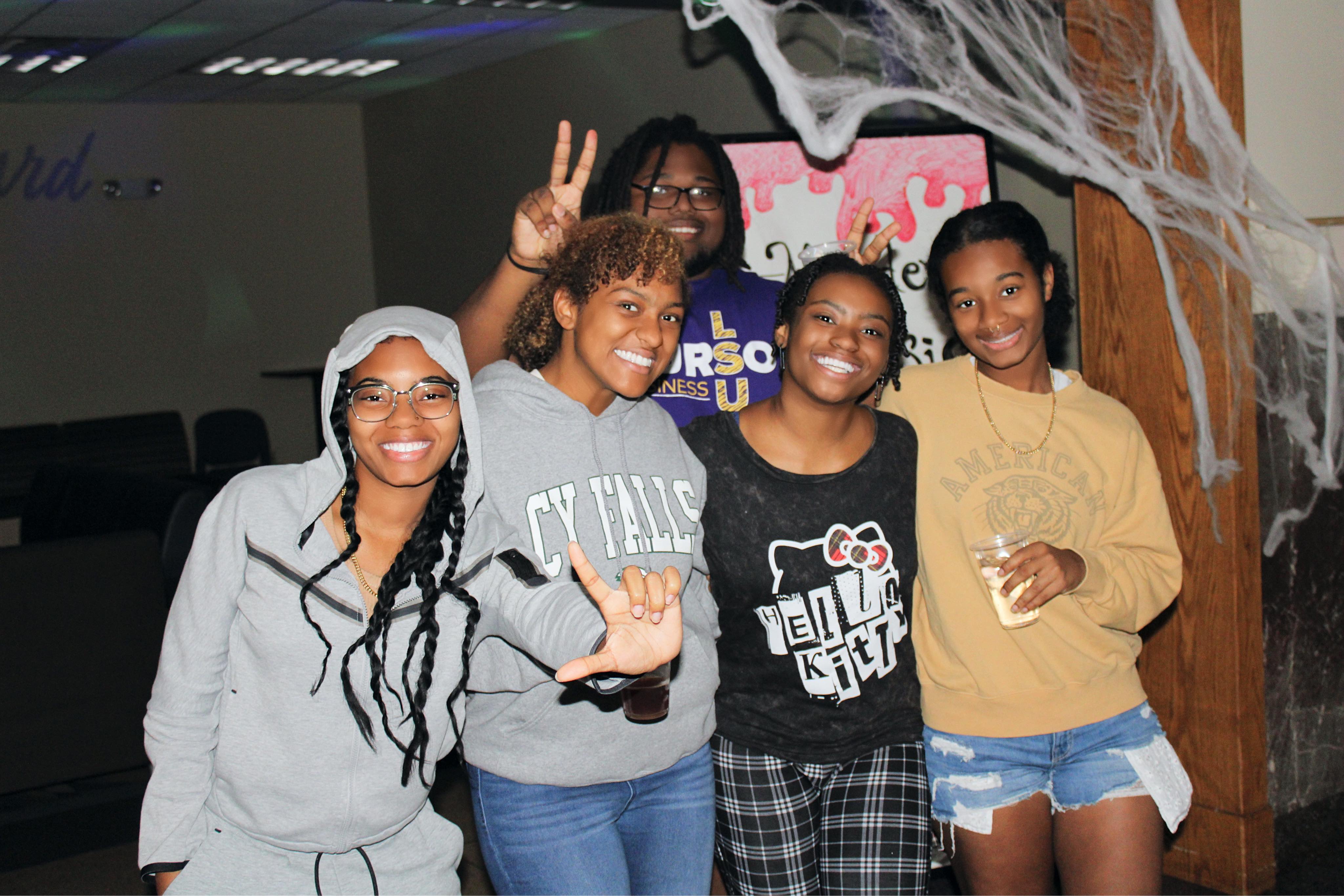 Students posing for a picture at a North and Broussard Hall event