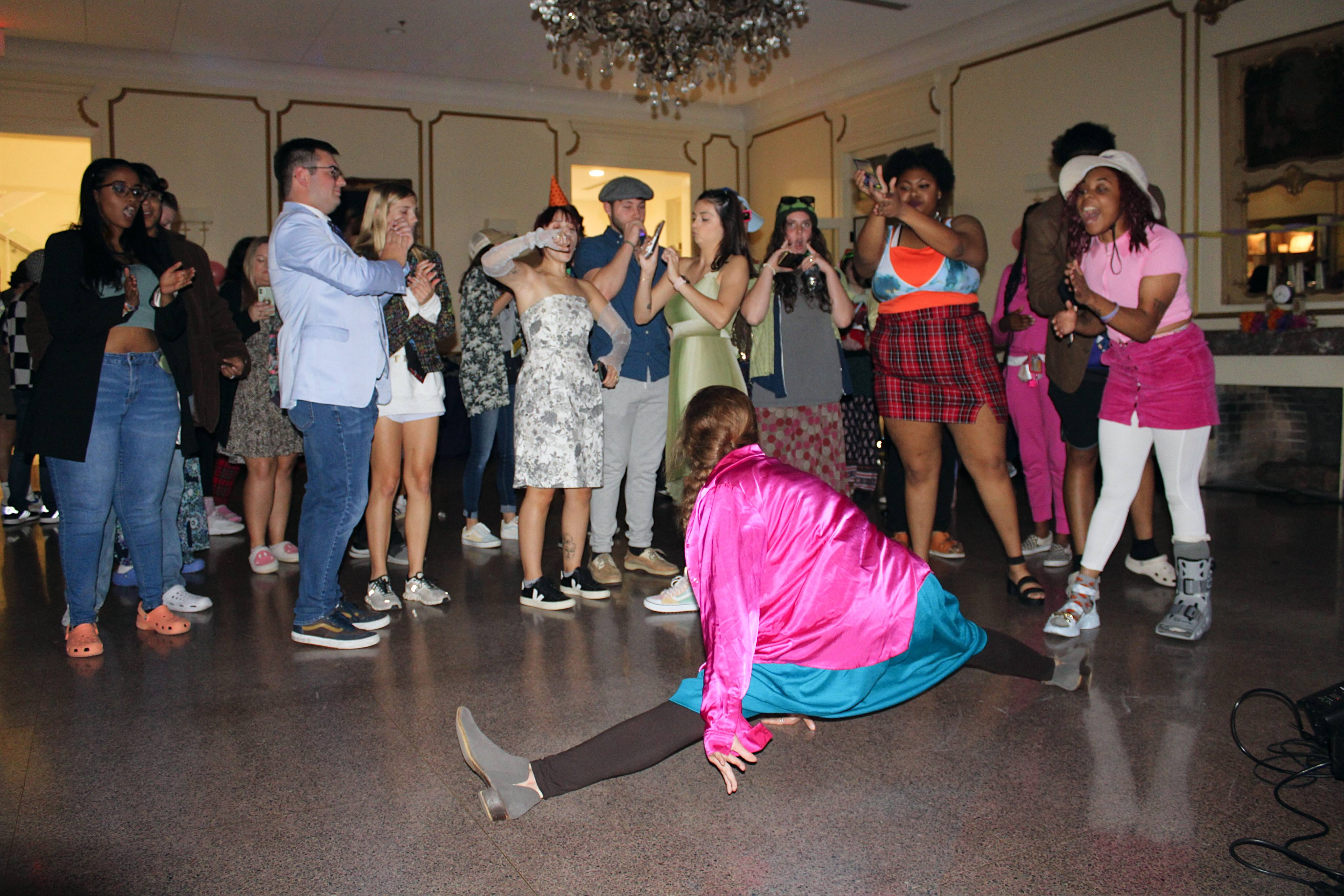 student doing the splits at Tacky Prom in the French House