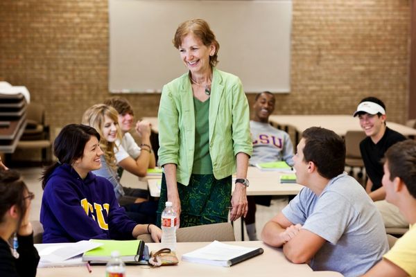 professor smiling with students