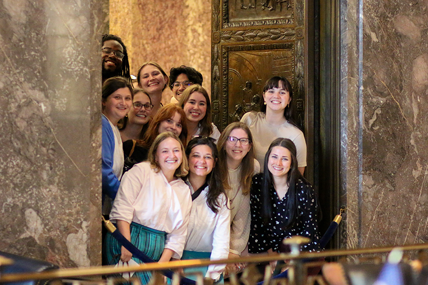 social work students smiling in a hallway at the State Capitol building
