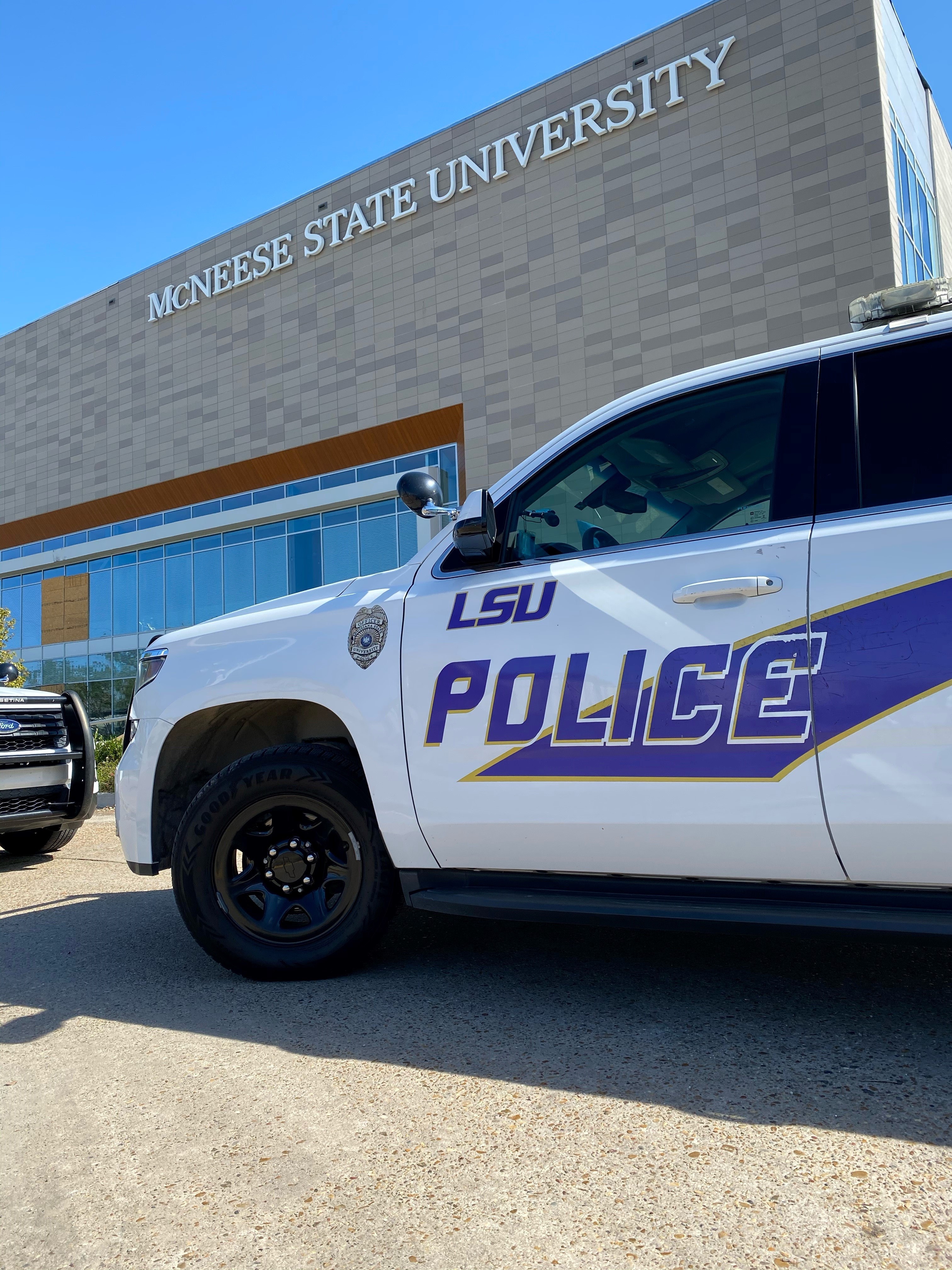 LSU PD vehicle parked in front of a McNeese State University building