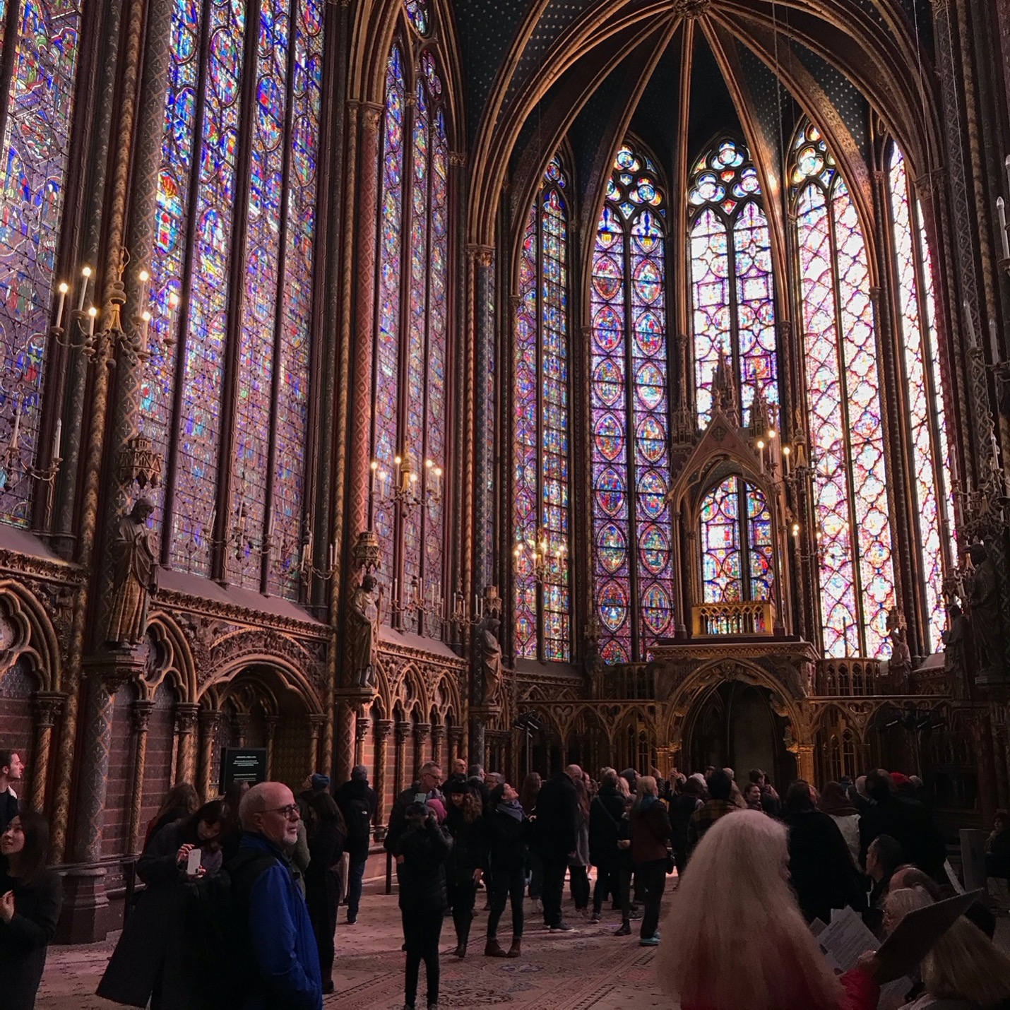 Inside the stained-glass chapel of Sainte-Chappelle in Paris, France with tourists.. 
