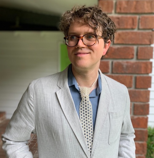 Sophia Ziegler Sophia smiling and looking off camera with brick background.