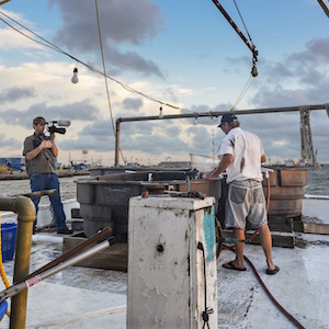 Students filming on a shrimp boat.
