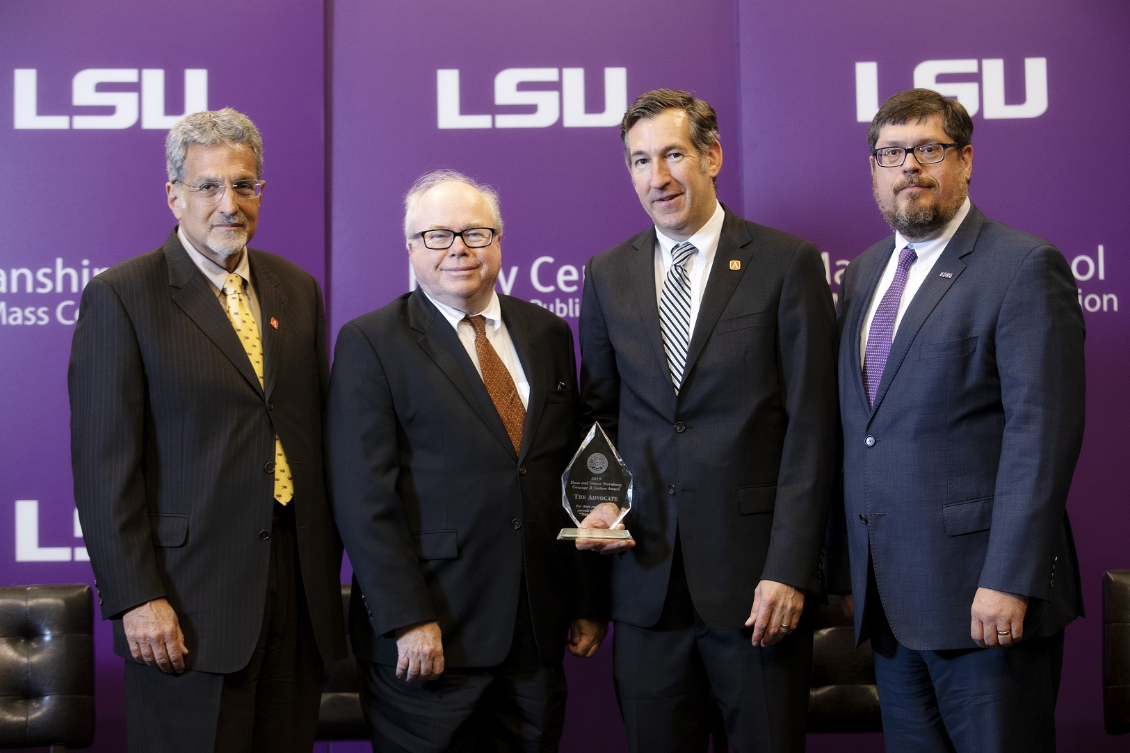 photo shows Advocate staff accepting the Courage & Justice Award: (L to R): Editor Peter Kovacs, Editorial Writer Lanny Keller, Gordon Russell, Managing Editor, Investigations; and Manship School Dean Martin Johnson.