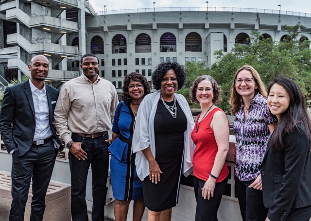 Mayor-President Broome poses in front of Tiger Stadium with panelists and guests from the Breaux Symposium