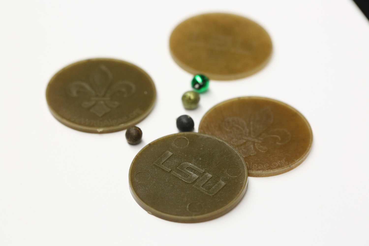 Biodegradable beads and doubloons developed at LSU